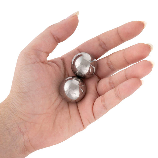 Small solid Baoding balls in a woman's hand. These steel Baoding balls are great for arthritic hands or carpal tunnel.